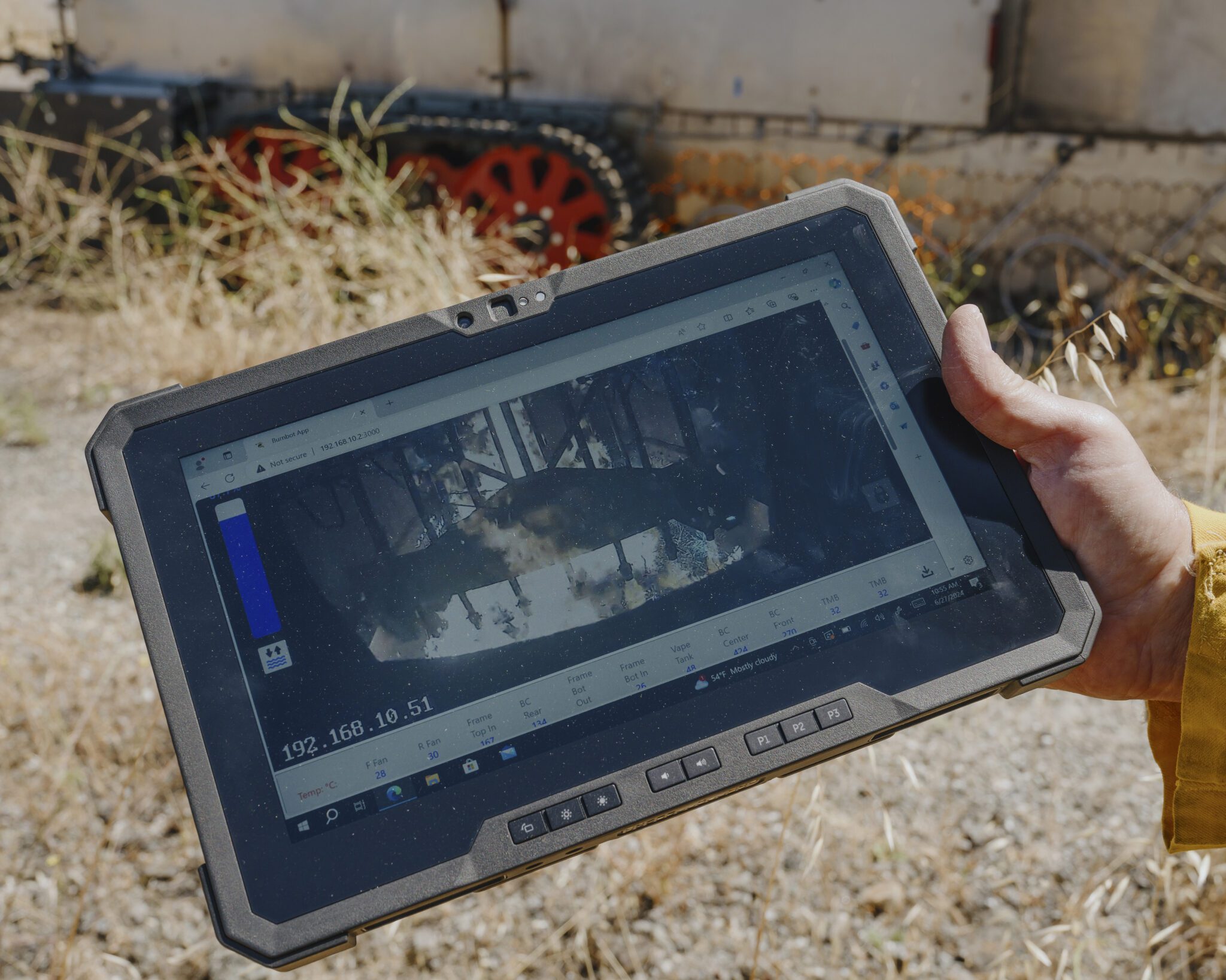 A wildland firefighter views a video of a test burn from the Burnbot.