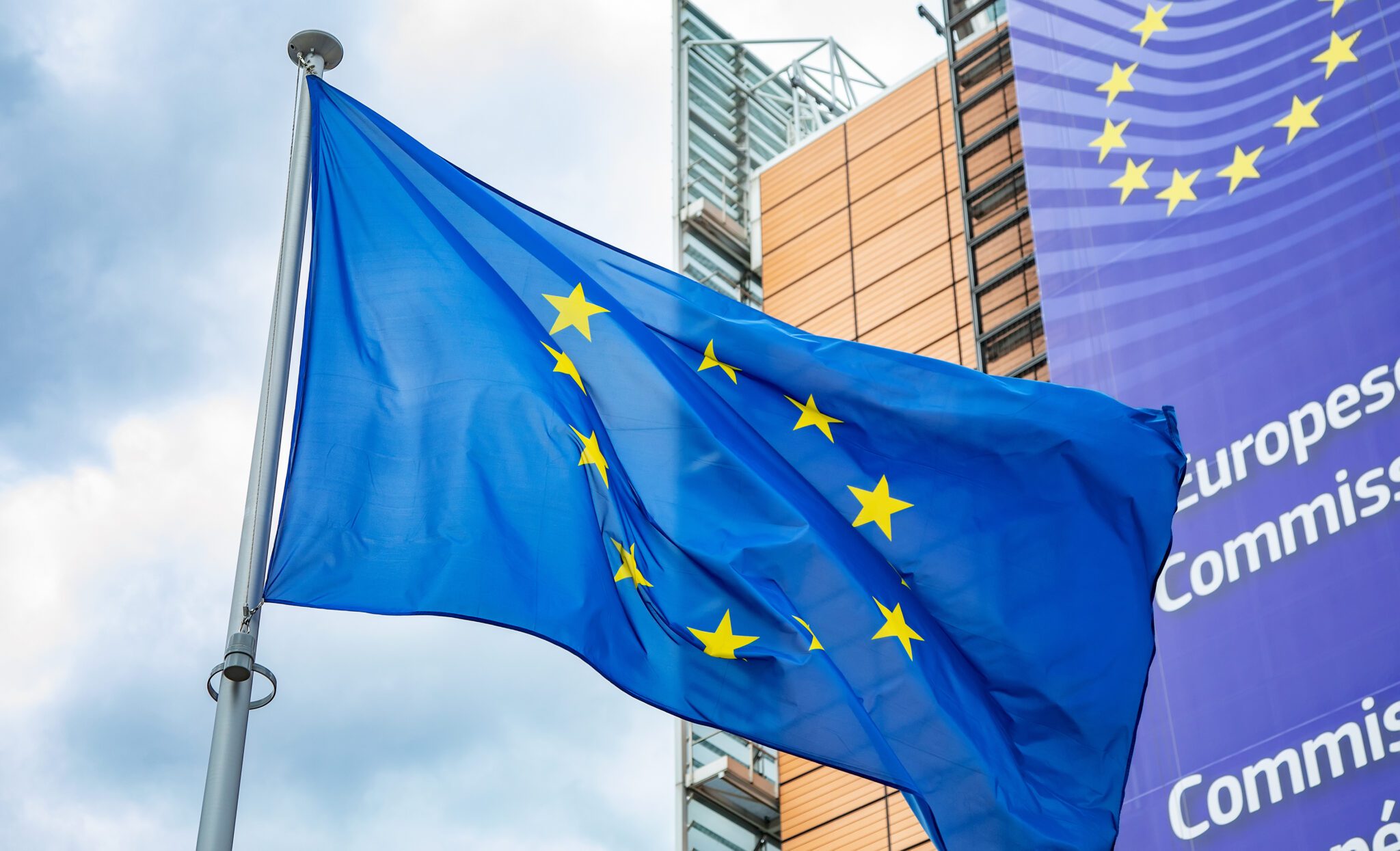 Brussels, Belgium - 21 May, 2022: European Union flag in front of the Berlaymont building, headquarters of European Commission.