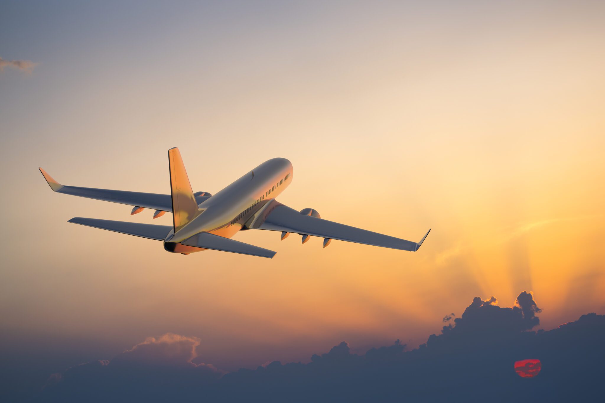 Passenger airplane flying above clouds in evening